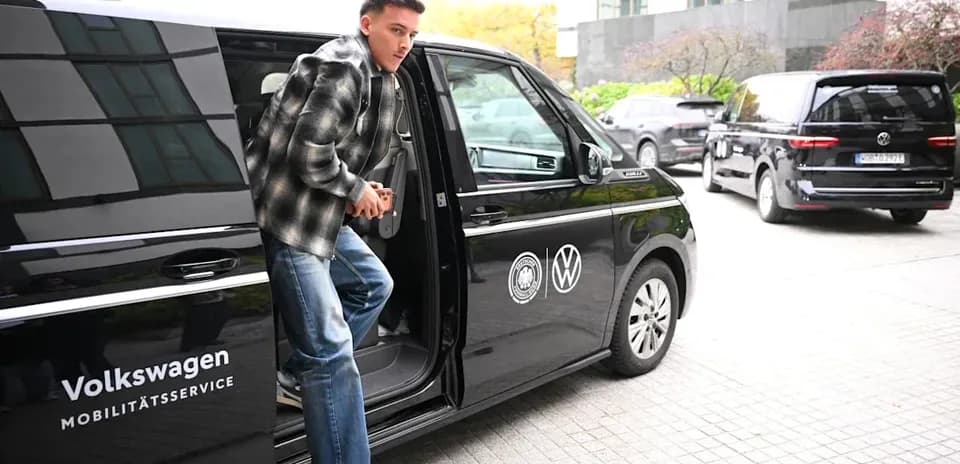 Player exiting Volkswagen vehicle at training location