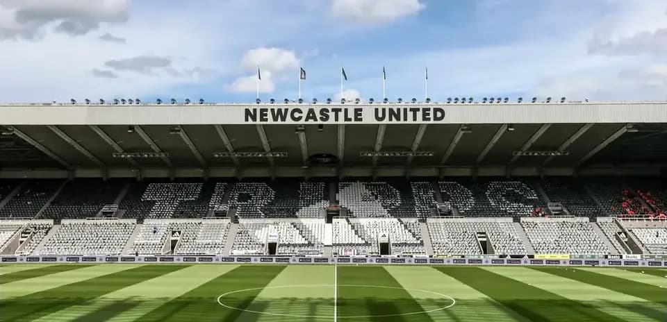 Newcastle United stadium with empty seats and green pitch