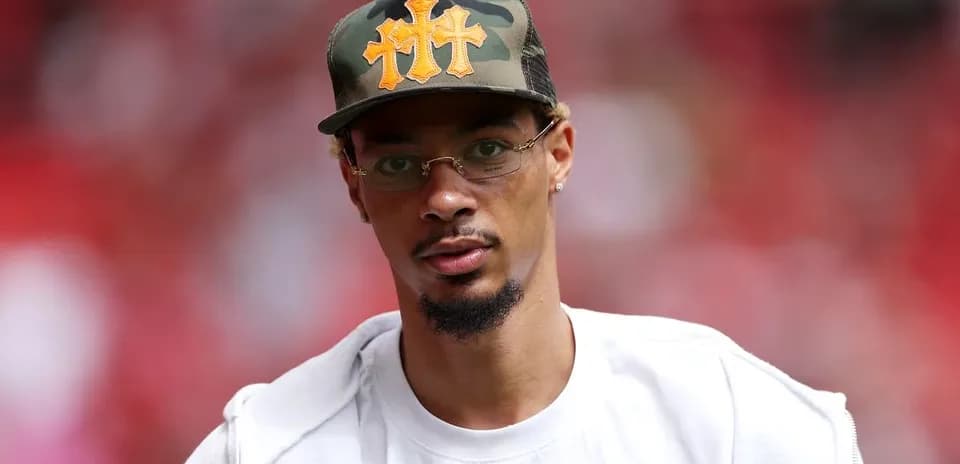 Man wearing a camo cap and glasses