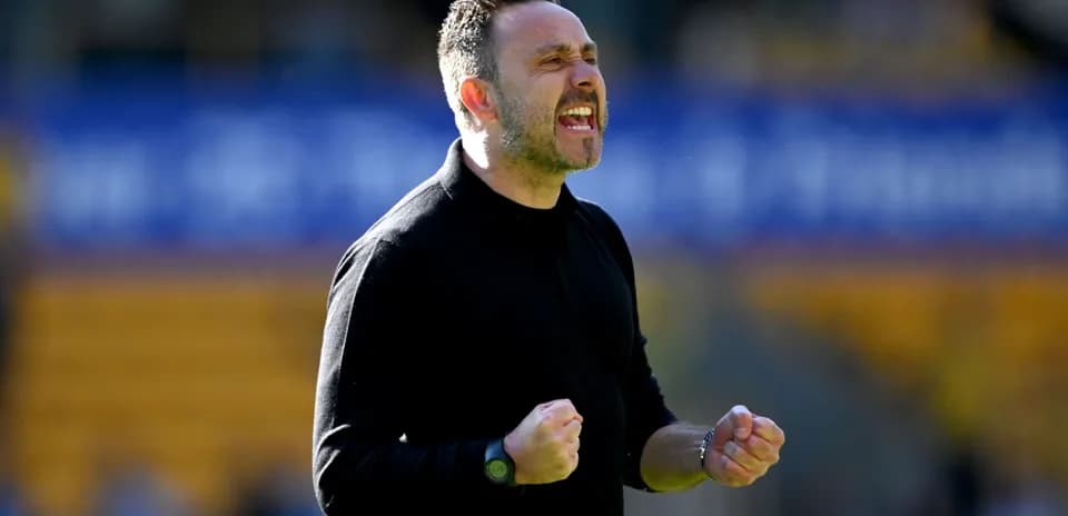 Manager celebrating passionately on the sidelines