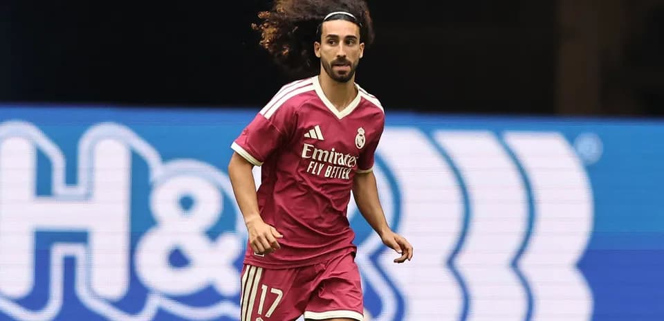 Player running on the field in pink Real Madrid jersey