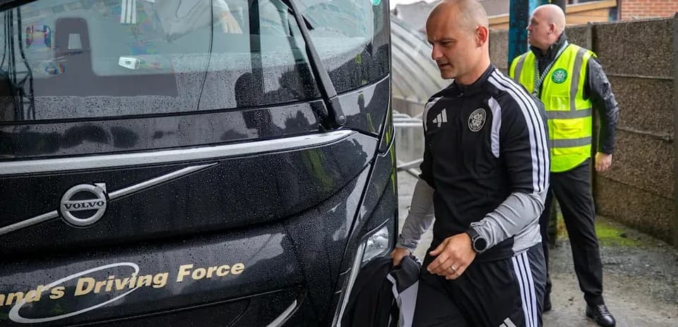 Team members boarding the bus in rainy weather