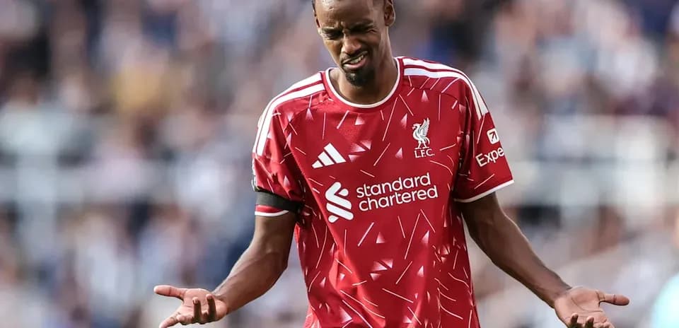 Player in Liverpool kit expressing frustration on pitch