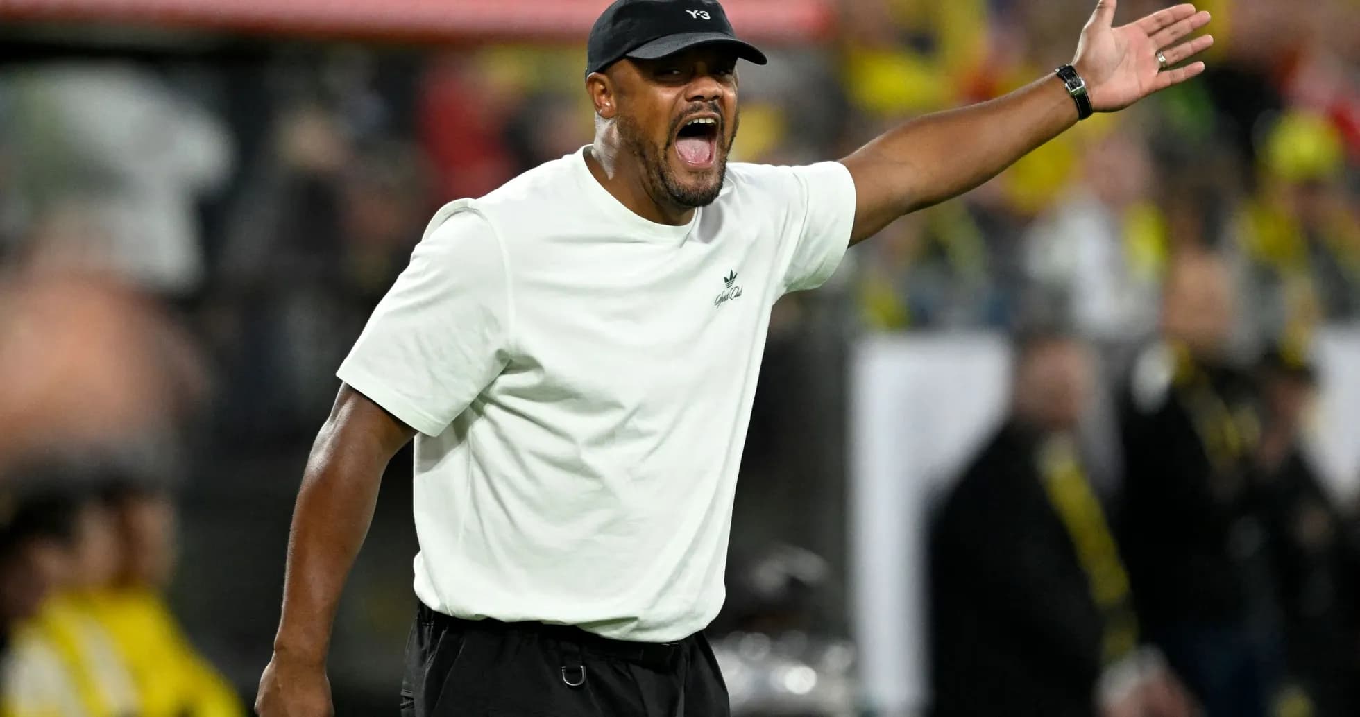 Coach gesturing and shouting on the sidelines