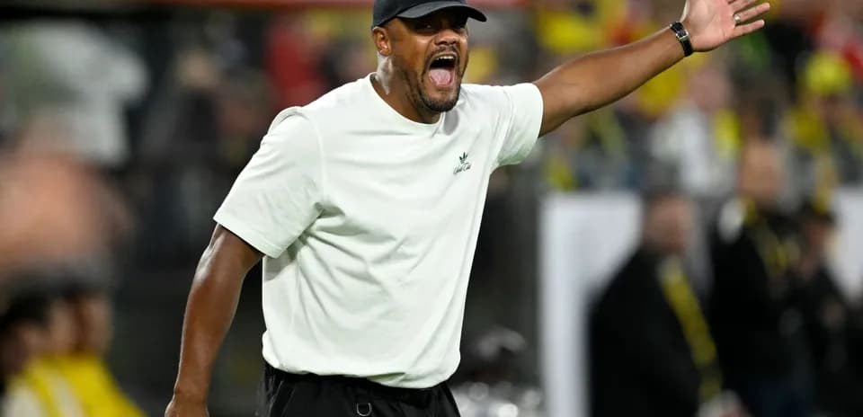 Coach gesturing and shouting on the sidelines