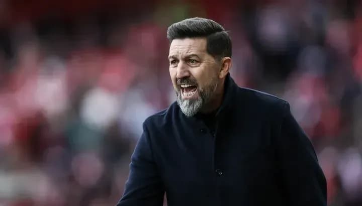 Manager giving instructions on the sidelines during match