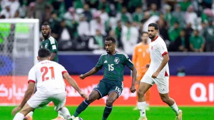 Saudi Arabia player dribbling past defenders during match