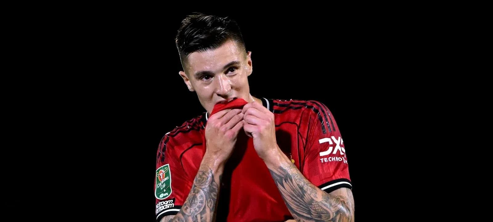 Player in red jersey biting his shirt