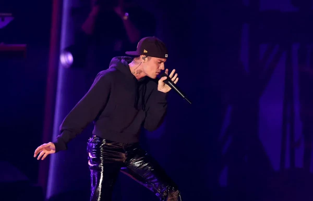 Performer singing into a microphone on stage