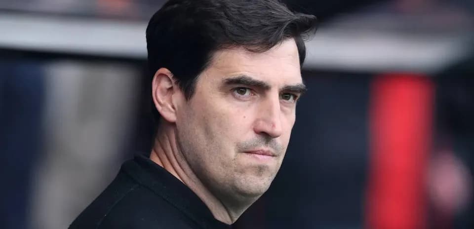 Coach observing from the sidelines during a match