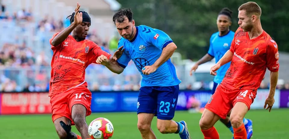 Players competing for the ball in football match