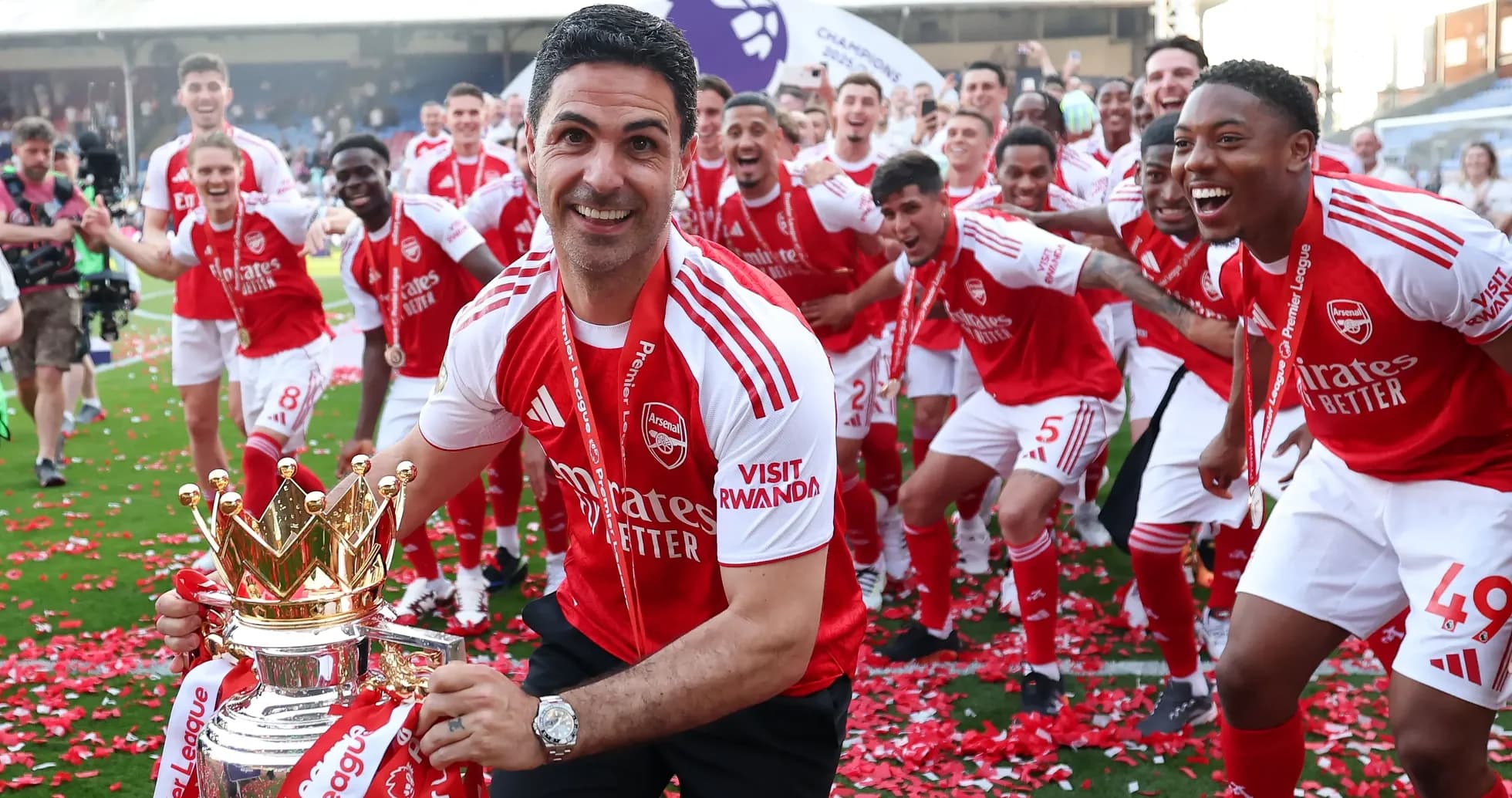 Arsenal team celebrating Premier League victory with trophy