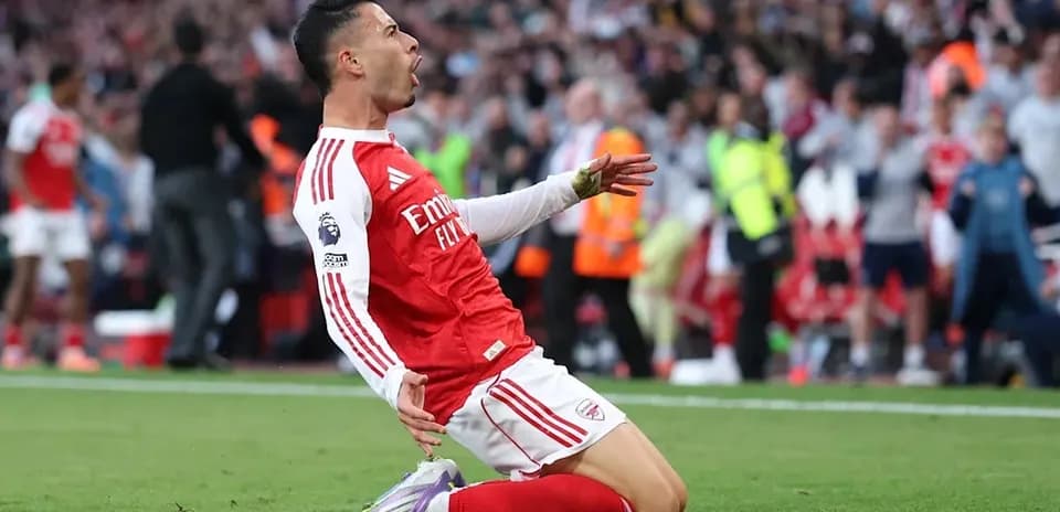 Arsenal player celebrating a goal on the pitch