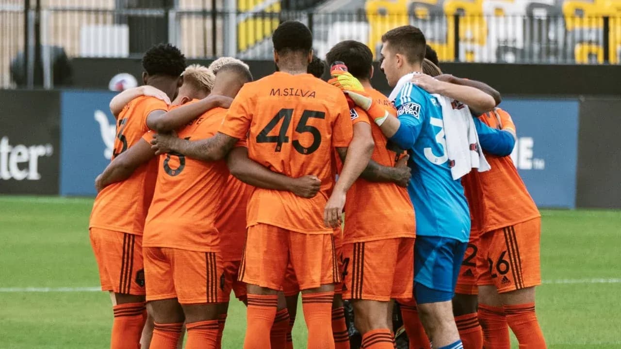 Houston Dynamo FC II players in team huddle