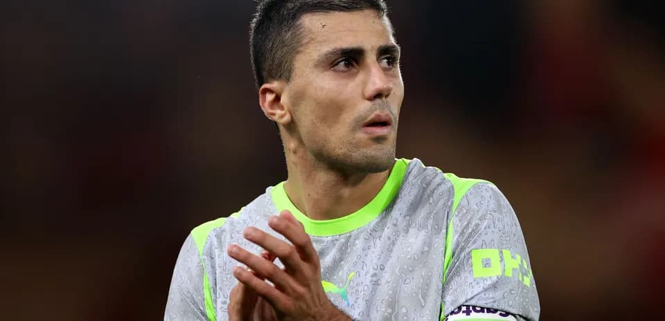 Player in goalkeeper jersey applauding on field