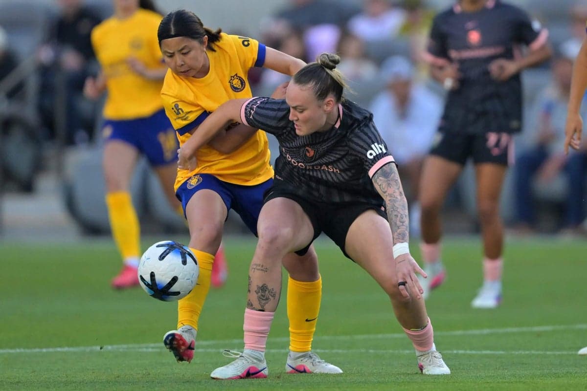 Players competing for the ball in NWSL match
