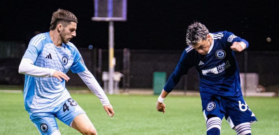 Two players competing for the ball in match