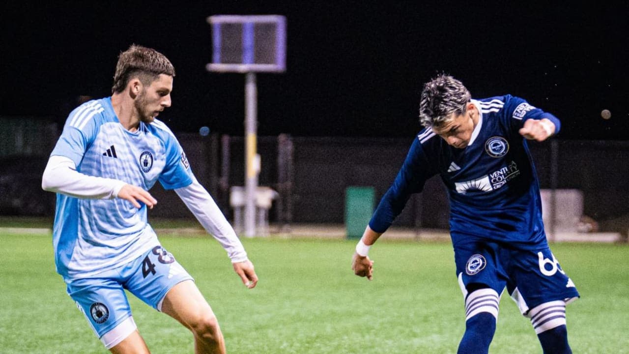 Two players competing for the ball in match