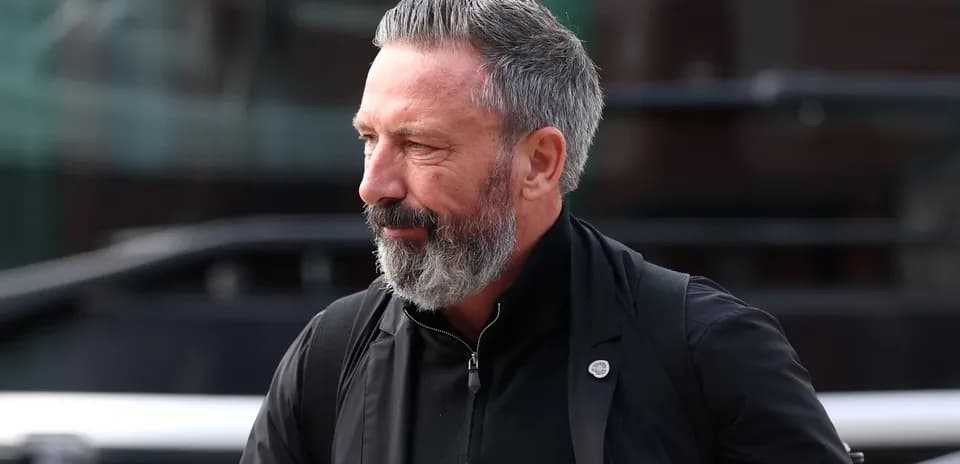 Man with beard walking near bus