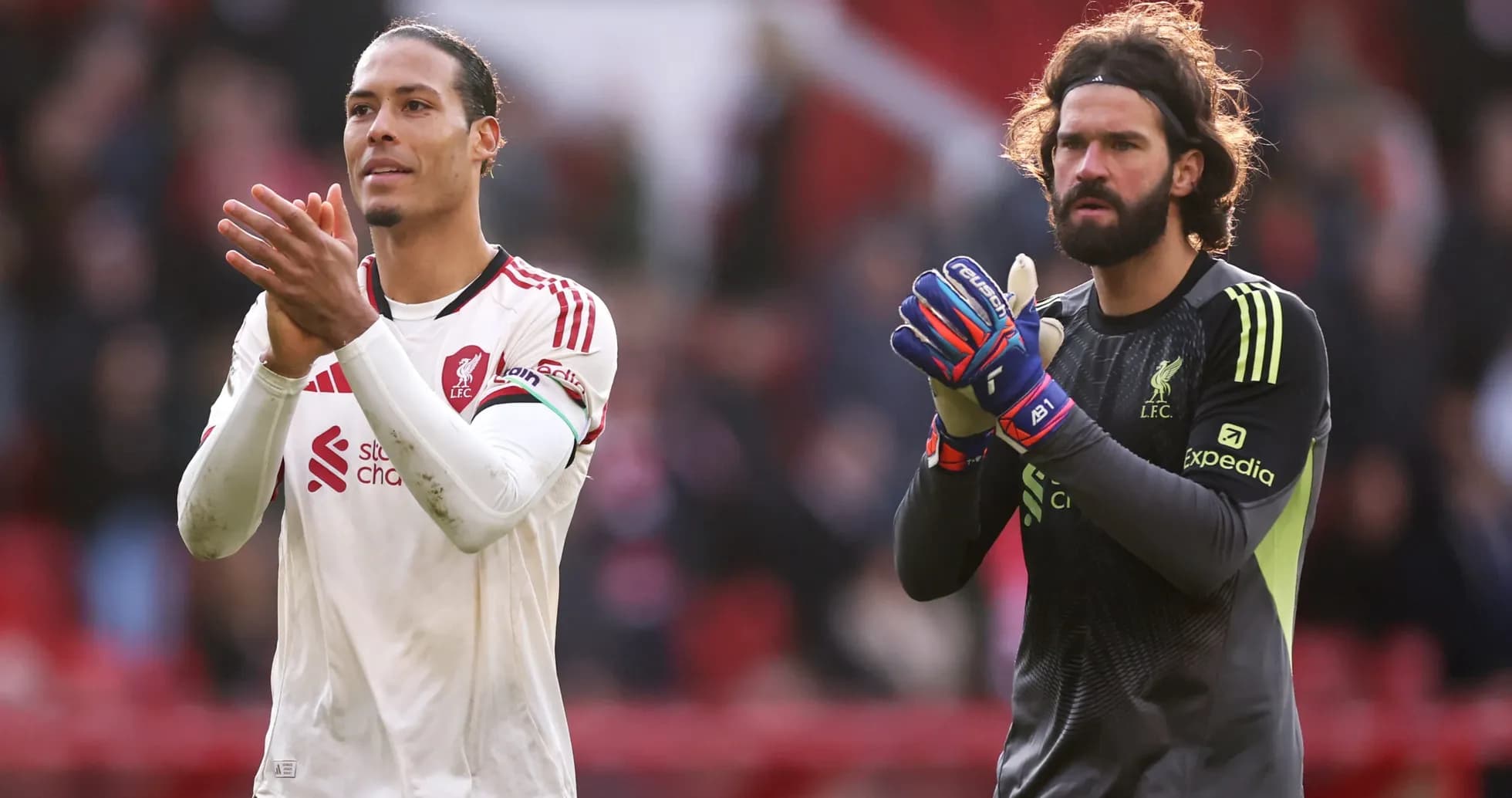 Liverpool players applauding fans after match