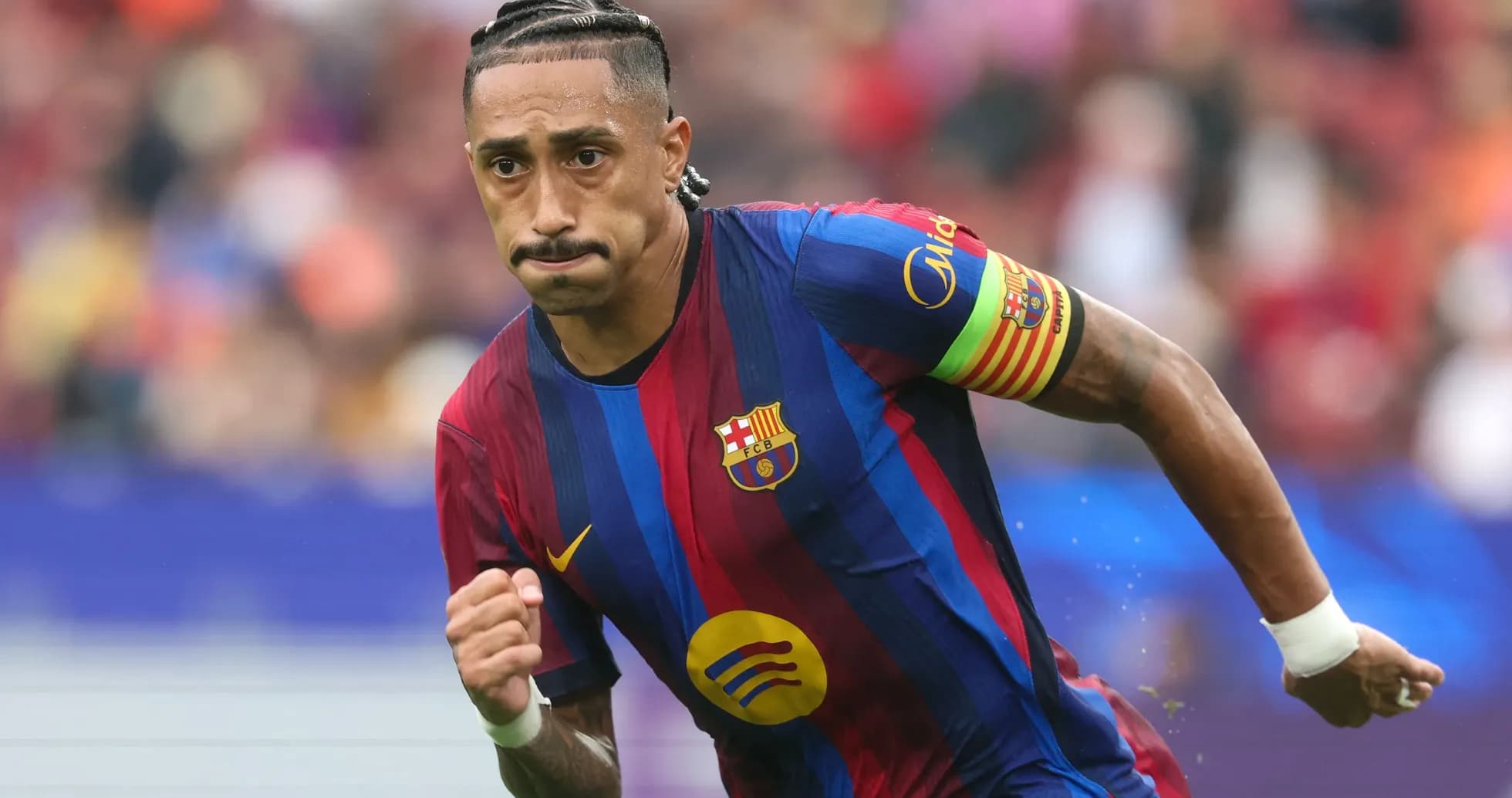 Player running on the field in FC Barcelona kit