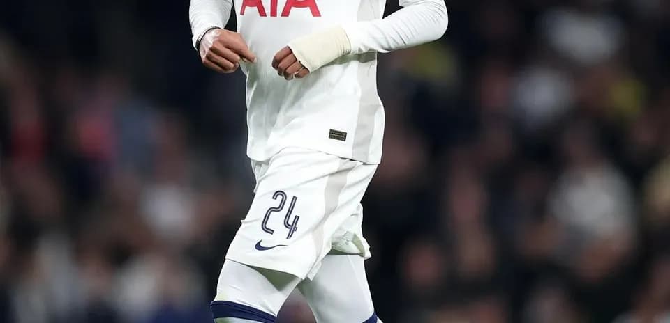 Player in Tottenham kit running with soccer ball