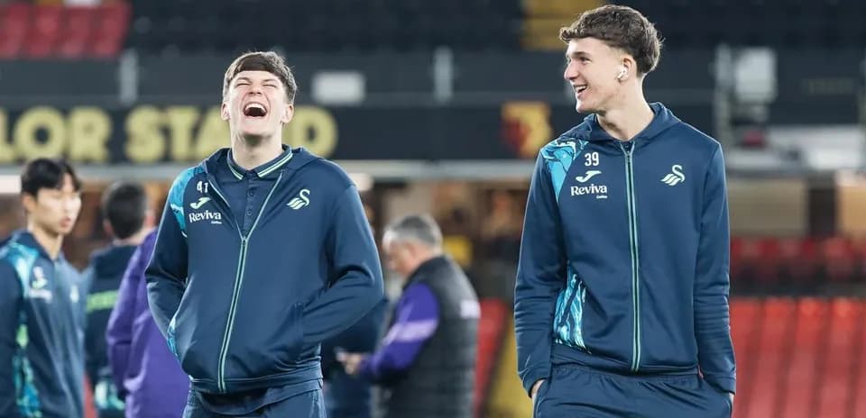 Swansea City players laughing during warm-up