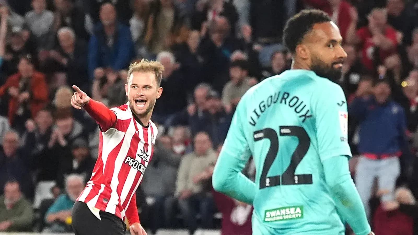Player celebrating a goal with teammate nearby