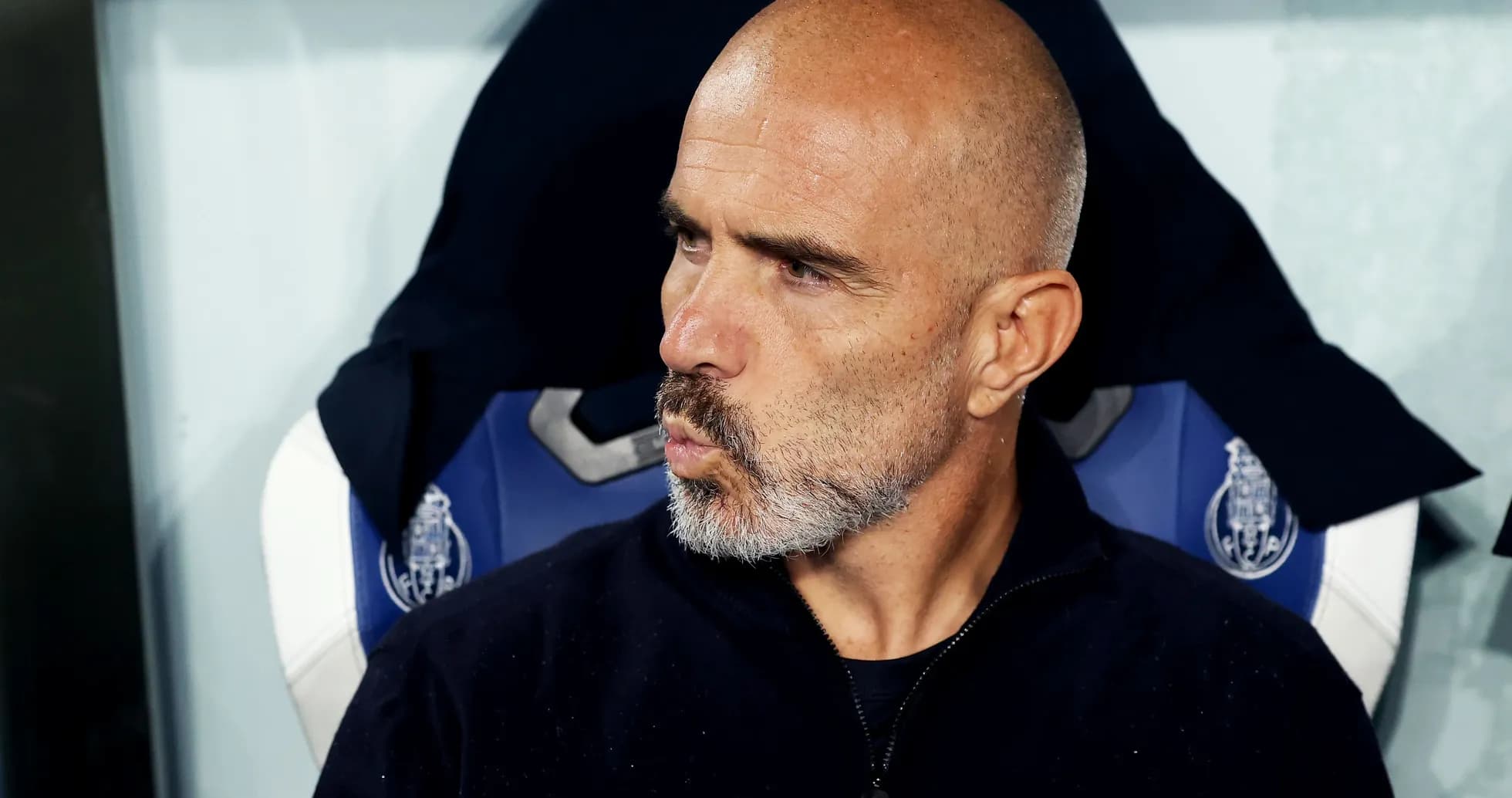 Coach sitting on the bench during a match