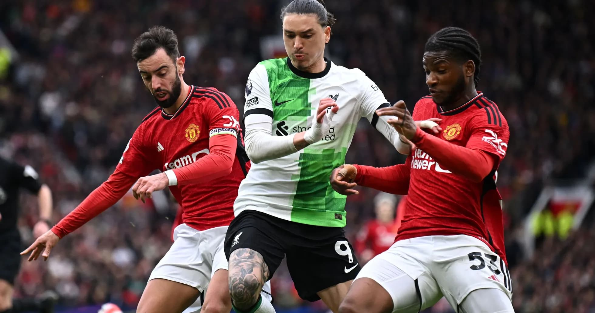 Liverpool and Manchester United players contesting the ball