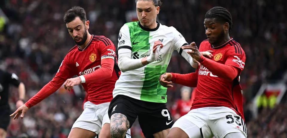 Liverpool and Manchester United players contesting the ball