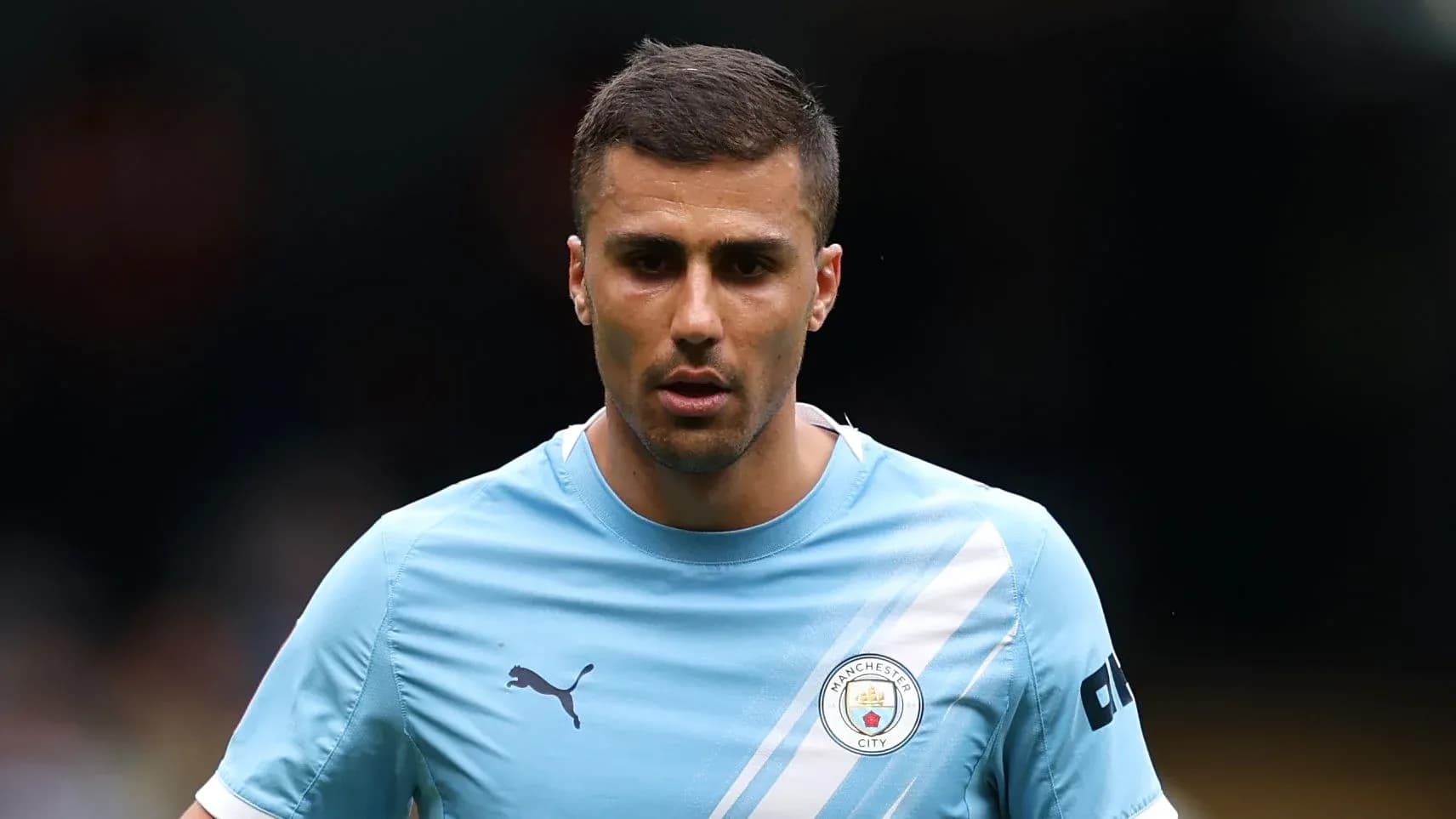 Player wearing Manchester City training kit on pitch