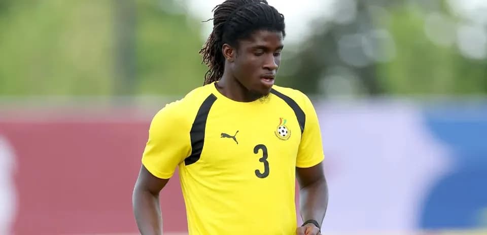 Player training in yellow jersey with Ghana emblem