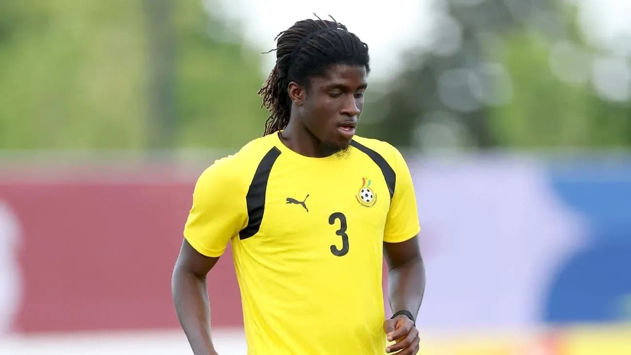 Player training in yellow jersey with Ghana emblem