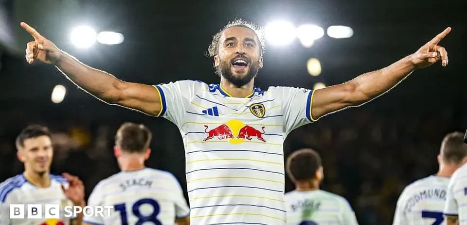 Player celebrating with teammates after scoring goal