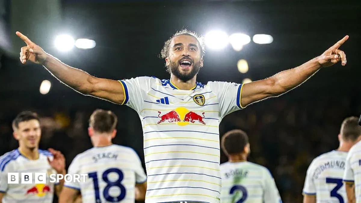 Player celebrating with teammates after scoring goal