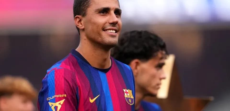Player smiling during celebration with teammates