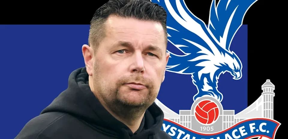 Coach in front of Crystal Palace F.C. logo