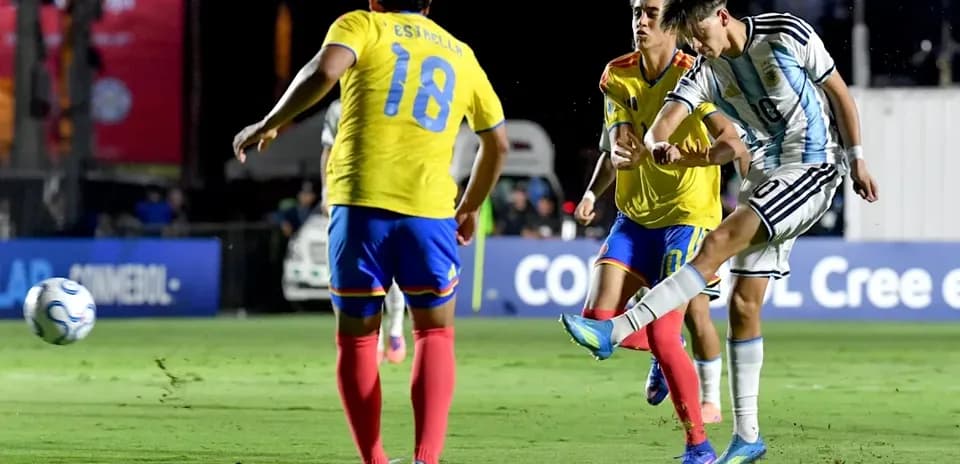 Argentinian player shooting while defenders approach