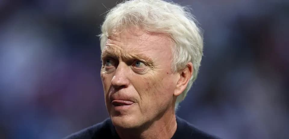 Football manager with light hair during match