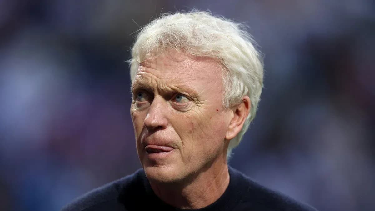Football manager with light hair during match