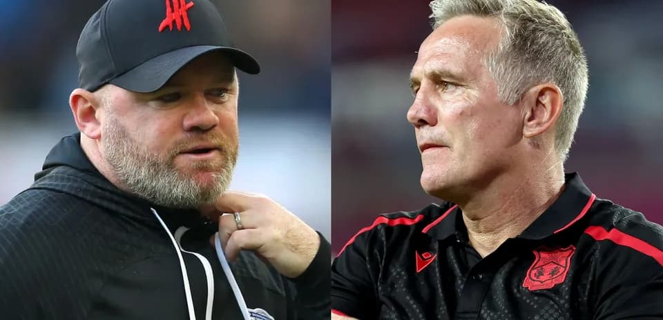 Two football managers discussing during a match