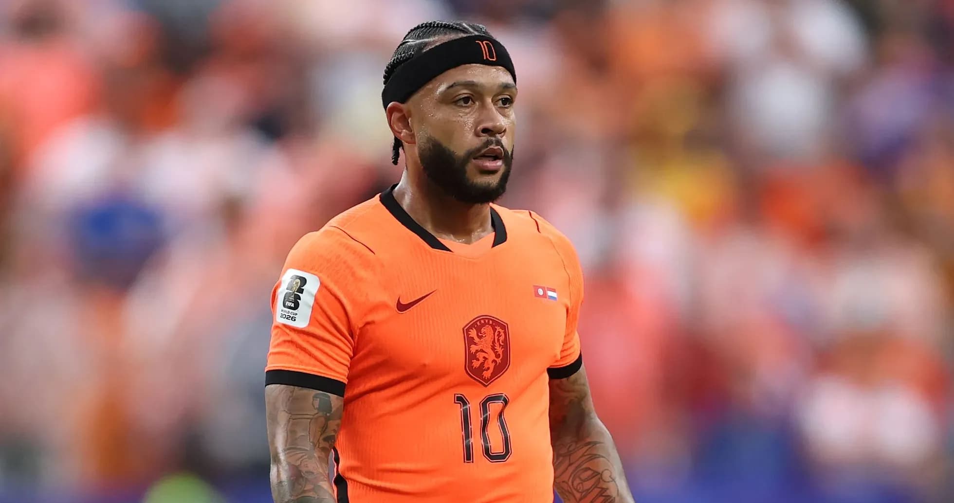 Player in orange jersey during football match