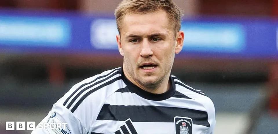 Player wearing black and white jersey on field