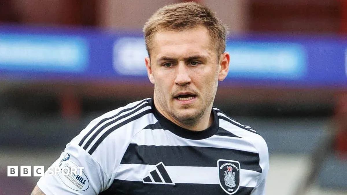Player wearing black and white jersey on field