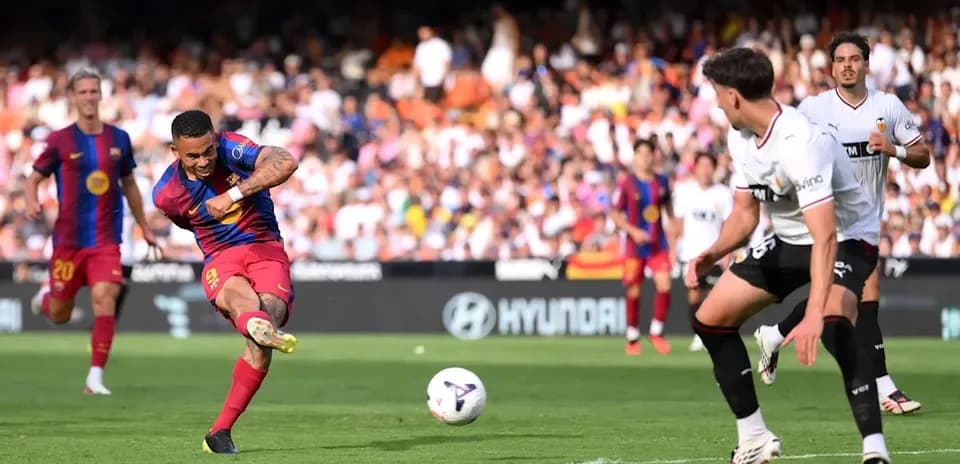 Barcelona player striking the ball in match action