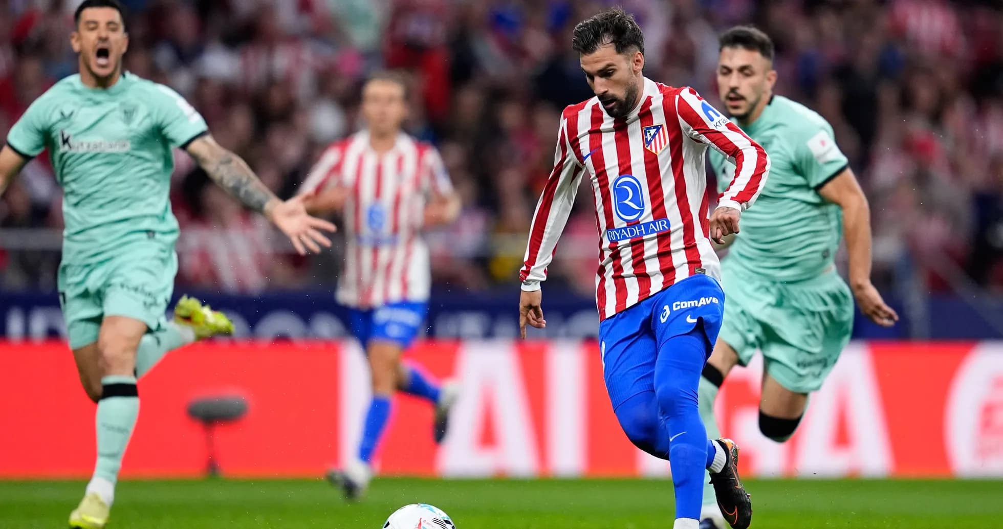 Atletico Madrid player dribbling during match