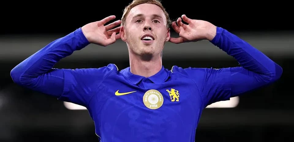 Player celebrating with hands on ears after scoring