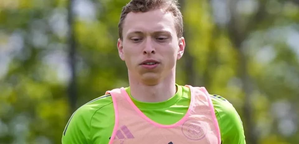 Goalkeeper training in green kit and pink vest