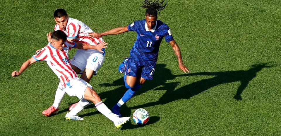 Paraguay and France players contesting for the ball